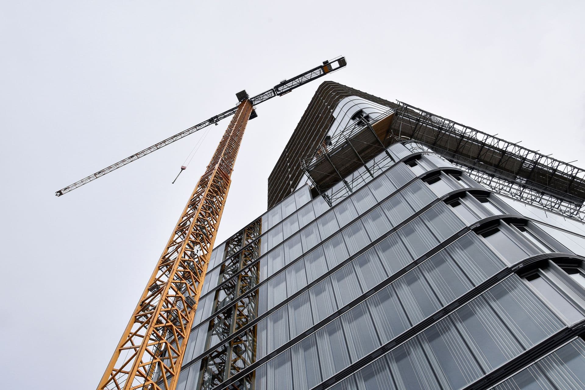 Tower crane beside a high-rise construction site